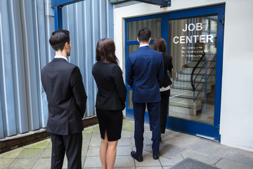 Businesspeople Standing At The Entrance Of Job Center