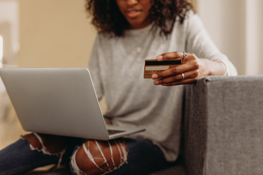Woman making online transaction using credit card