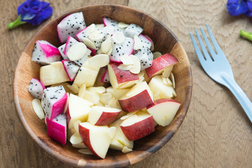 Clean food healthy food concept , mixed fruit with apple, dragon fruit, banana and almond