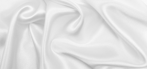 Obraz premium Smooth elegant white silk or satin luxury cloth texture as wedding background. Luxurious background design