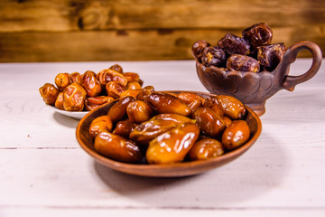 Date fruits on the white wooden table