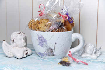 Decorative big beautiful cup with biscuits in gift package.