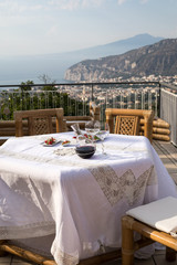 Prepared for supper table on the terrace overlooking the Bay of Naples and  Vesuvius. Sorrento. Italy