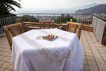 Prepared for supper table on the terrace overlooking the Bay of Naples and  Vesuvius. Sorrento. Italy