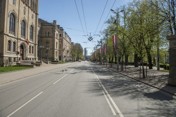 A middle of the street with cables and flags.