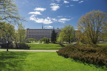 Fototapeta na wymiar A city park with trees and buildings.