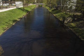 A river canal connecting a par with dark waters.