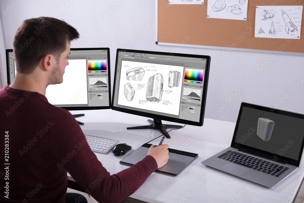Poster Designer Drawing Suitcase On Computer Using Graphic Tablet
