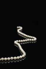pearls laid on a black background.