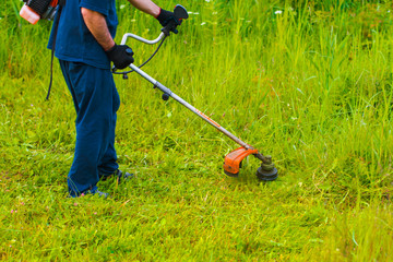man mowing grass with a lawn mower