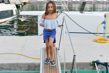 fashionable cute girl is ready to go with luxury boat