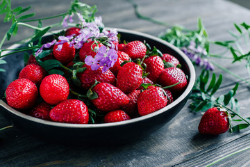 Strawberries in a bowl on a wooden table
