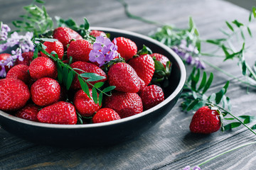 Strawberries in a bowl on a wooden table