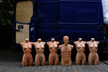 naked female and male display dummies lined up on a market