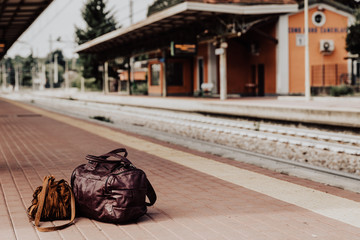 Travel bags of tourist at the platform in railway train statoin.