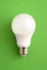 White lightbulb on a green background