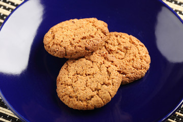Oat biscuits on a dark background.