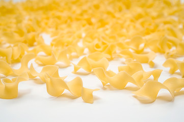 pasta "tagliatelle girate" on a white background. Selective focus