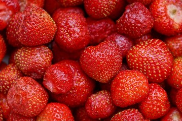 red vegetative texture of ripe strawberries in a heap