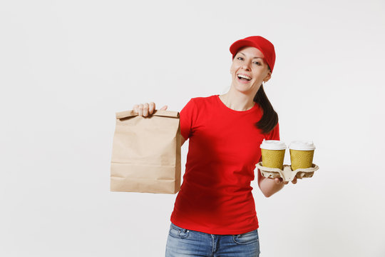 Woman in red cap, t-shirt giving fast food order isolated on white background. Female courier holding paper packet with food, coffee. Products delivery from shop or restaurant to your home. Copy space
