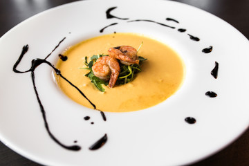 European international fusion cuisine, a beautiful dish on a white plate decorated with herbs and vegetables. a professional chef has prepared a delicious meal.