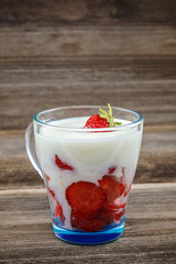 Fresh strawberries with sour cream in a bowl