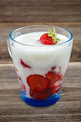 Fresh strawberries with sour cream in a bowl