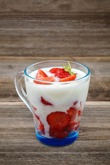 Fresh strawberries with sour cream in a bowl