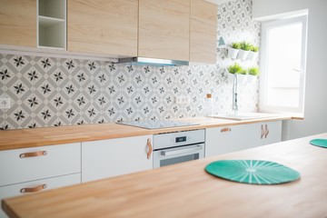 Open bright kitchen with white furniture. Island kitchen. - obrazy, fototapety, plakaty