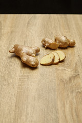 Ginger root sliced on wooden table