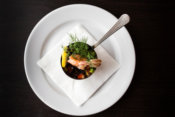 European international fusion cuisine, a beautiful dish on a white plate decorated with herbs and vegetables. a professional chef has prepared a delicious meal.