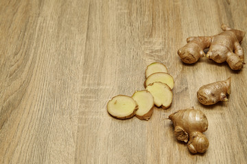 Ginger root sliced on wooden table