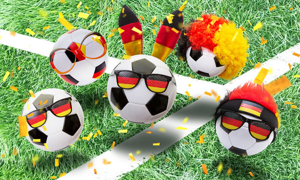   German soccer fans cheer on the field with fan articles and confetti
