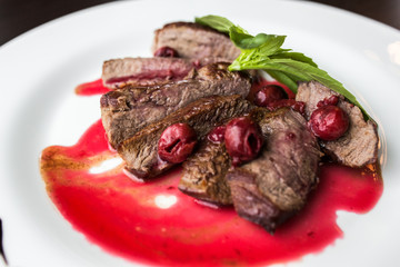 European international fusion cuisine, a beautiful dish on a white plate decorated with herbs and vegetables. a professional chef has prepared a delicious meal.