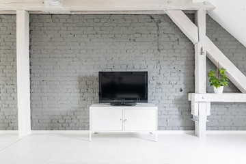 Modern flat lcd television set on white cabinet.