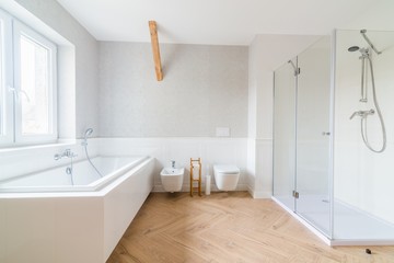 Naklejka na ściany i meble Bathtub and glass shower cabin in loft bathroom.