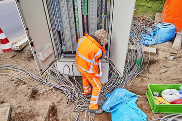 Netherlands, Haarlem - 19-06-2018: man connecting cables for traffic lights