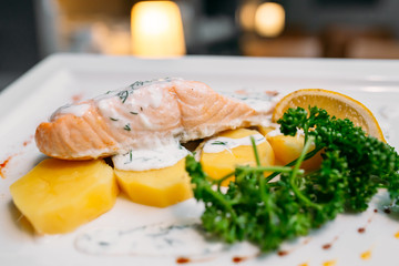 European international fusion cuisine, a beautiful dish on a white plate decorated with herbs and vegetables. a professional chef has prepared a delicious meal.