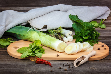 Asparagus, onion and parsley green fresh on a wooden