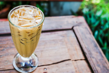 A coffee glass in the garden on wooden floor.