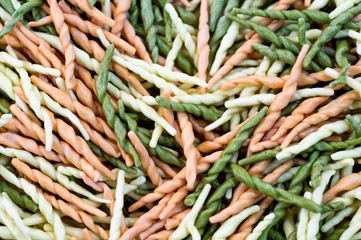 Plate-heart, pasta, space for text. Multicolored pasta in a wooden plate. I love macaroni