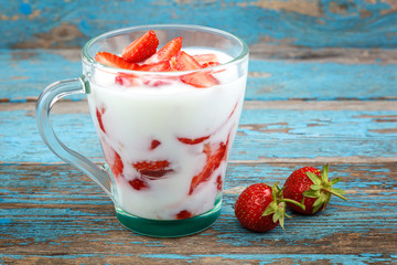 Fresh strawberries with sour cream in a bowl