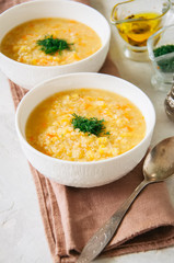 Lentil and bulgur soup puree in a white bowl on a white stone ba