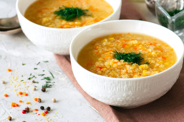 Lentil and bulgur soup puree in a white bowl on a white stone ba