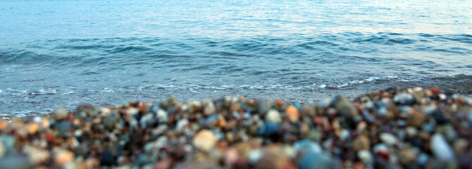 Waves washing over gravel beach, macro shot.