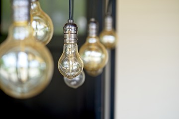 Interior design of lamp.Decorative antique style filament light bulbs hanging. Lighting lamp under the ceiling. Interior design of Vintage, Retro and industrial style lamps decorated