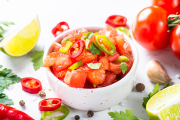 Salsa sauce and ingredients on white.
