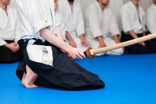 Aikidoka holds a bokken during the training of aikido