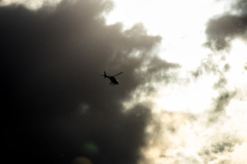 Helicopter, flying in cloudy evening light