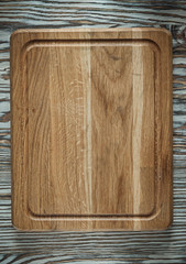 Chopping board on vintage wooden surface